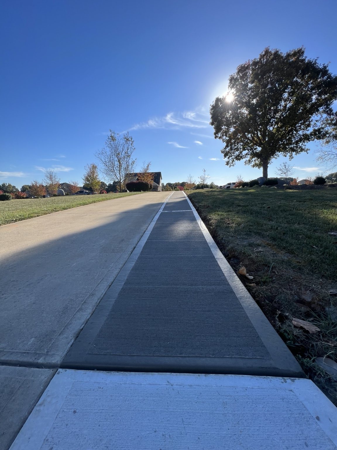 Concrete sidewalk beside driveway